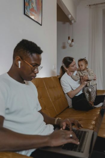 Smiling young couple embracing while looking at smartphone